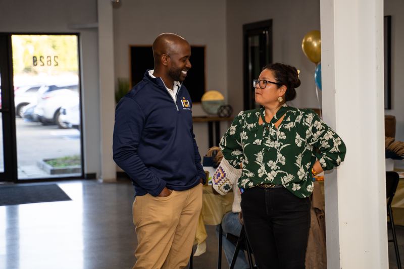 A man and a woman in conversation near the entrance.